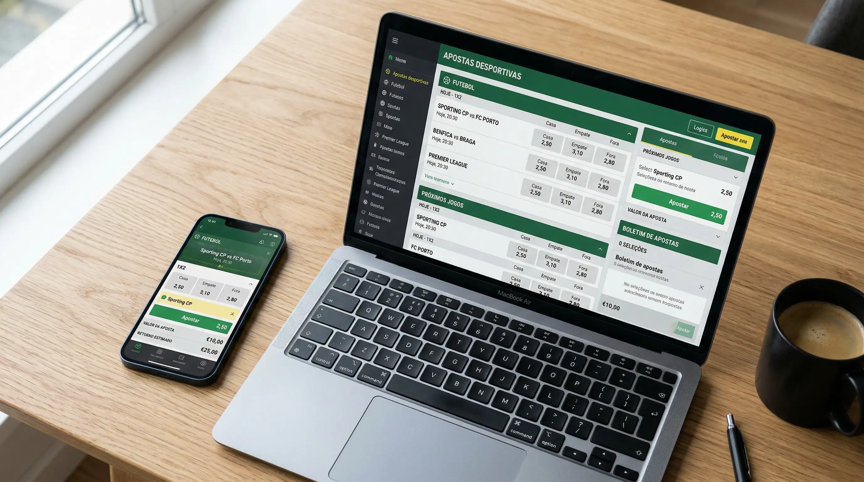Telemóvel com aplicação de apostas desportivas numa mesa junto a um portátil
